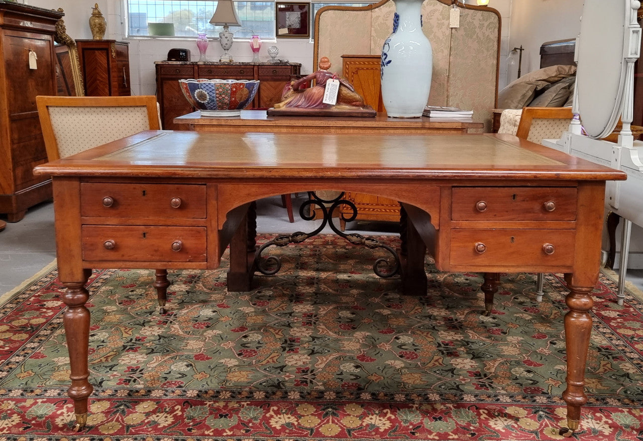 English Cedar full partners desk with attractive tooled leather top, four drawers either side and on caster wheels. In good original detailed condition.