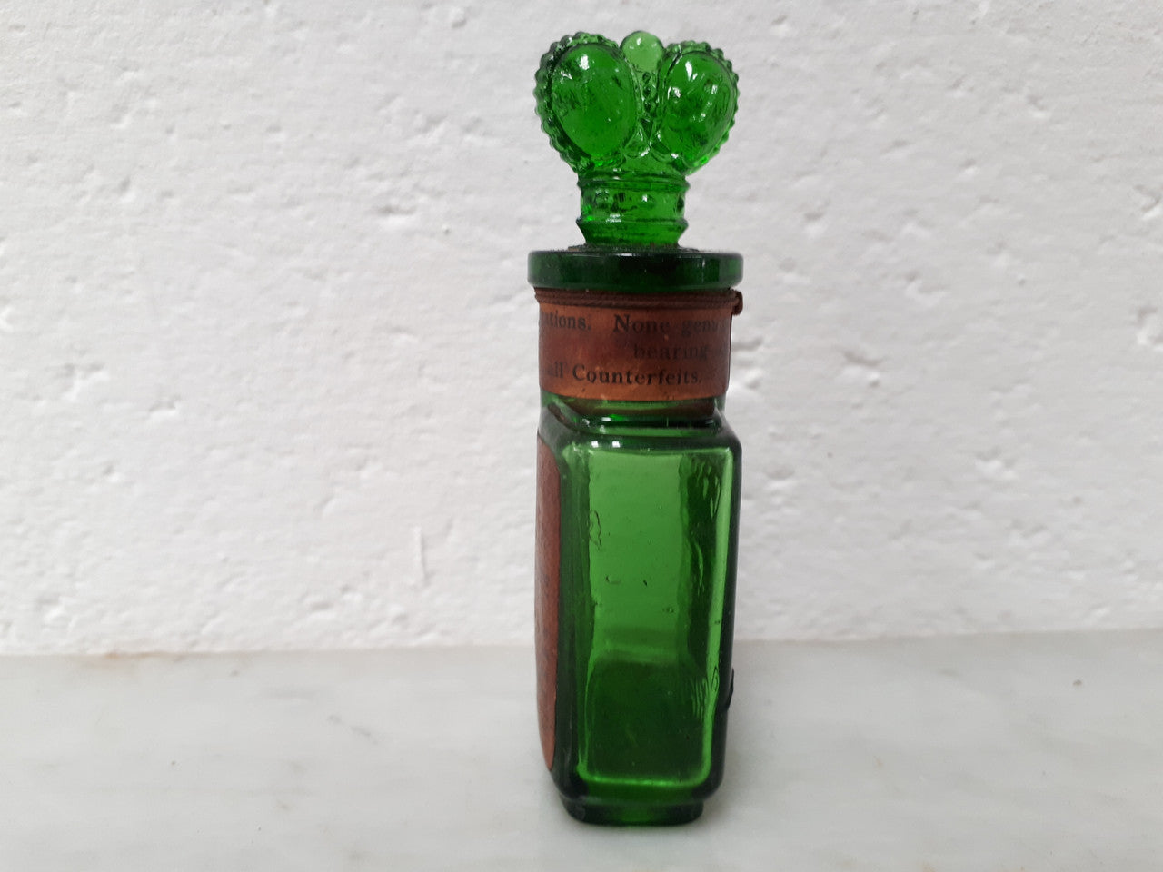 Victorian green glass Crown perfume bottle. In good original condition.