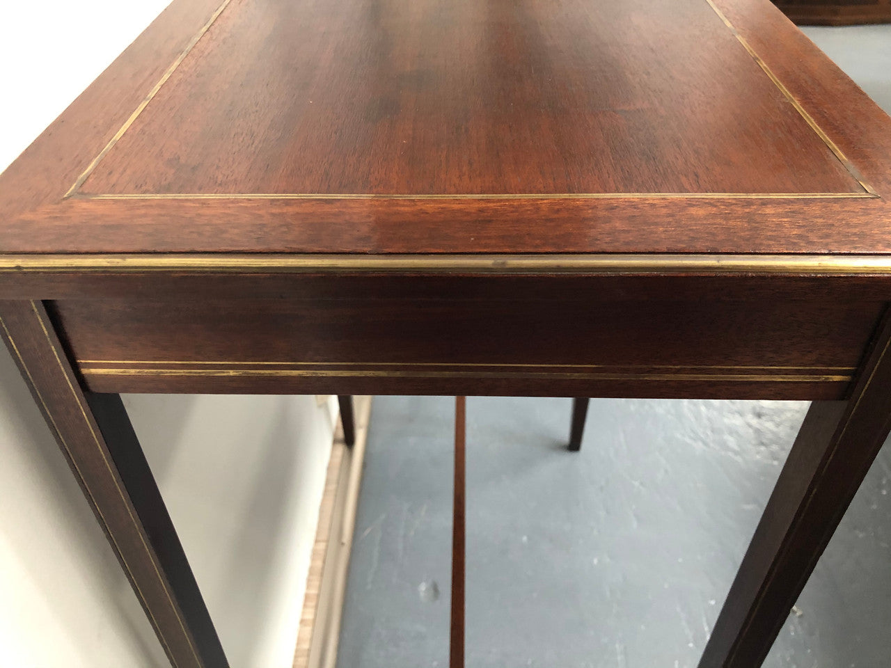 Elegant rectangular mahogany French brass inlaid occasional table. Is in good original condition.