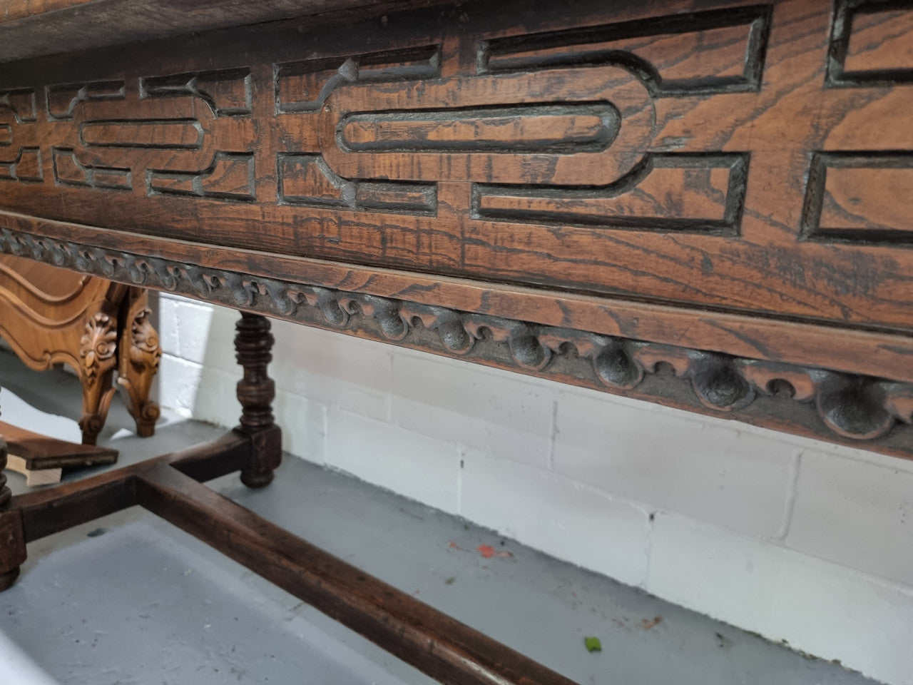 Rare and Charming 17th Century Spanish Walnut serving / side table. It has an incredible one piece walnut top with amazing character and colour. The base displays the original patina aswell as three drawers with carving and remnants of original locks. Superbly turned legs terminating on a stretcher base. Could be used as a large entrance console table, a side table or in a dining area as a serving table. In good original detailed condition especially considering its age.