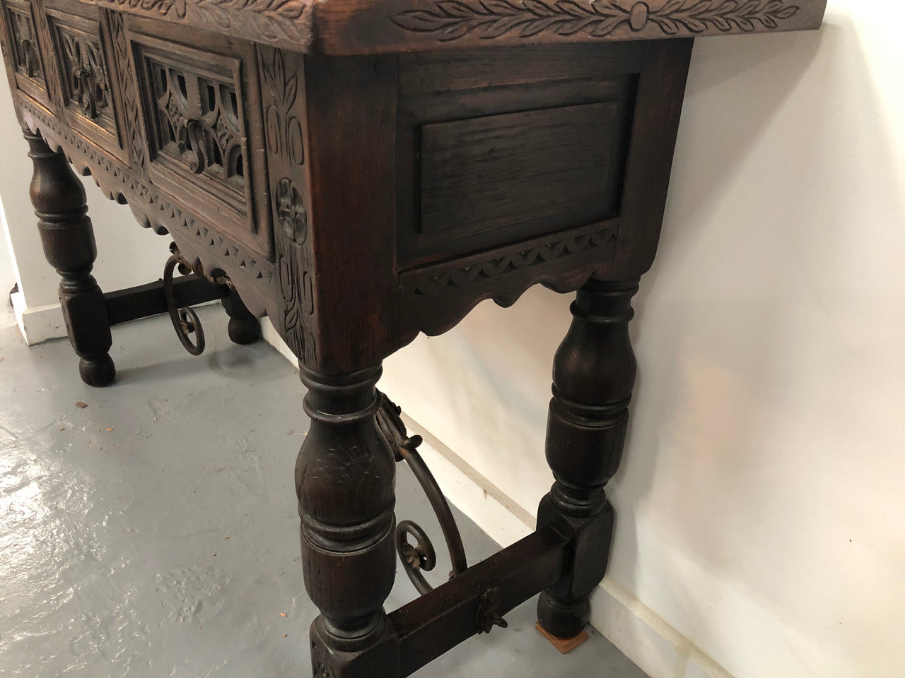 Spanish late 19th century carved oak three drawers console/side table. Superb wrought iron undercarriage. In good condition. Circa 1900's.