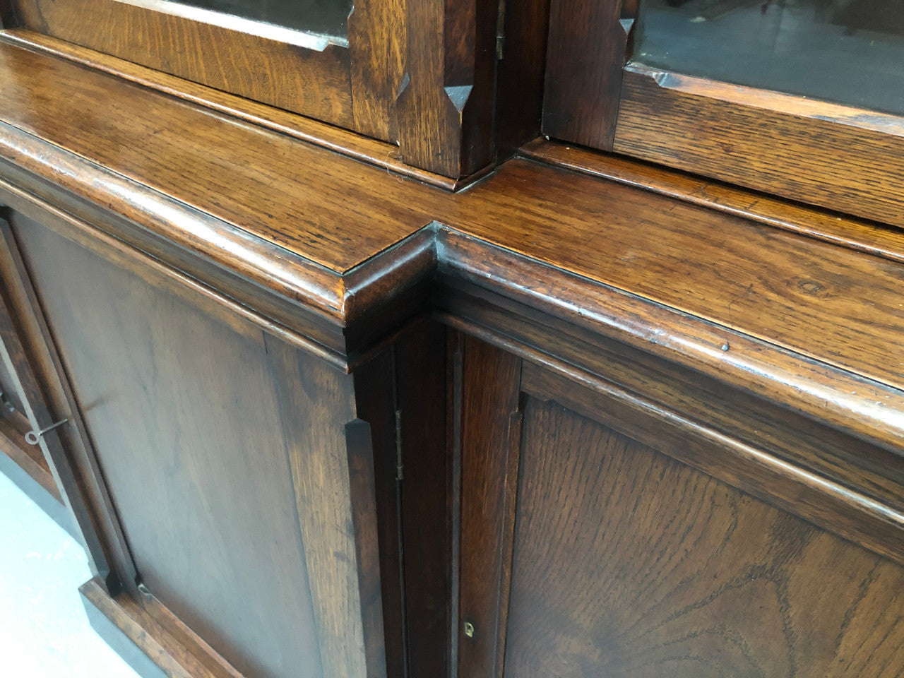 Amazing six-door Oak English bookcase sourced from France. The top section has adjustable shelves and plenty of storage space below which has fixed shelves. Keys and locks in working condition. In good original detailed condition. Circa 1880.