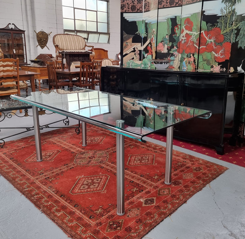 Striking and distinctive Vintage FIAM Italia Designer curved edge glass desk. FIAM was founded in 1973 by Vittorio Livio and has become synonymous with glass culture in Italy and the World. FIAM is still manufacturing today, in collaboration with various Designers, and has won numerous awards and is represented in various international museums. 
Condition: Evidence of use with minor scratches to the surface and a small chip that has been repaired. Overall, in very good condition with one repaired chip to t