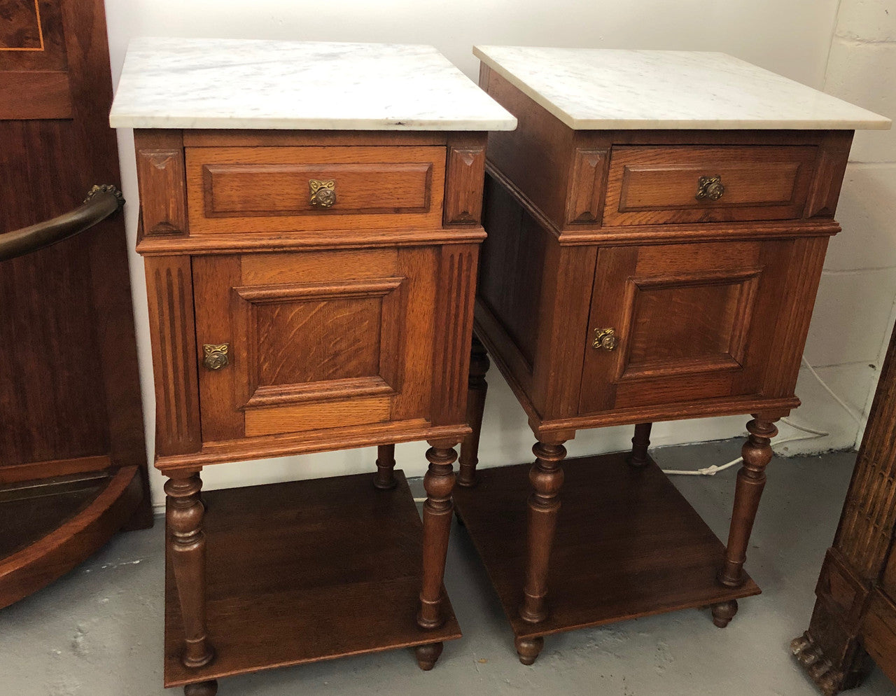 A lovely pair of French Oak, marble top bedside cabinets with a cupboard and drawer in good original condition.