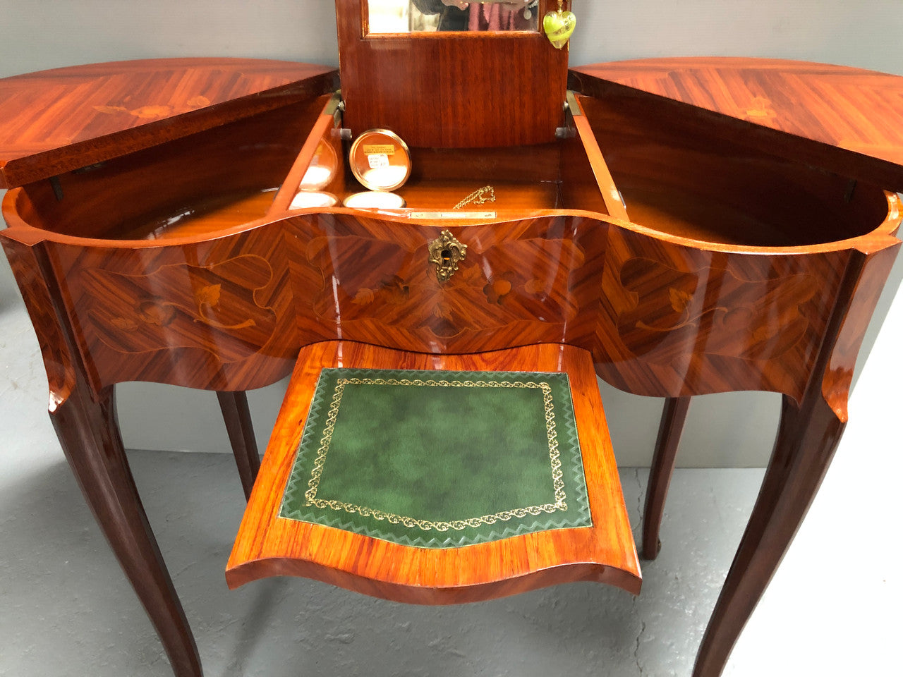 French Mahogany hidden dressing table with beautiful marquetry inlay. In good restored condition. Circa: 1950's