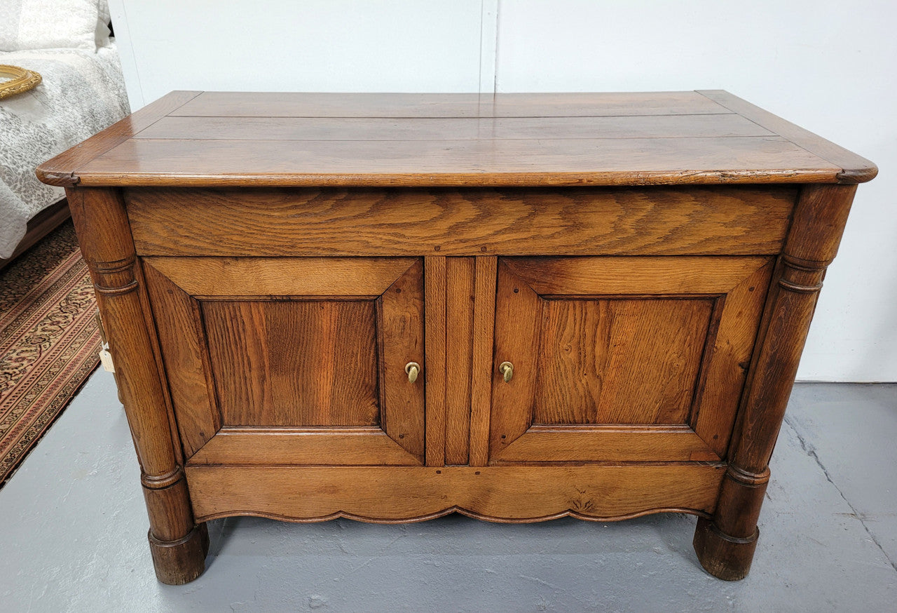 French 19th Century Oak dough bin buffet. The heavy solid top lifts upto reveal a half barrel compartment where traditionally flour and yeast were poured, mixed and proofed to grow into a nice dough.
Although originally intended for dough this would make an ideally TV cabinet with the two doors opening with plenty of storage.