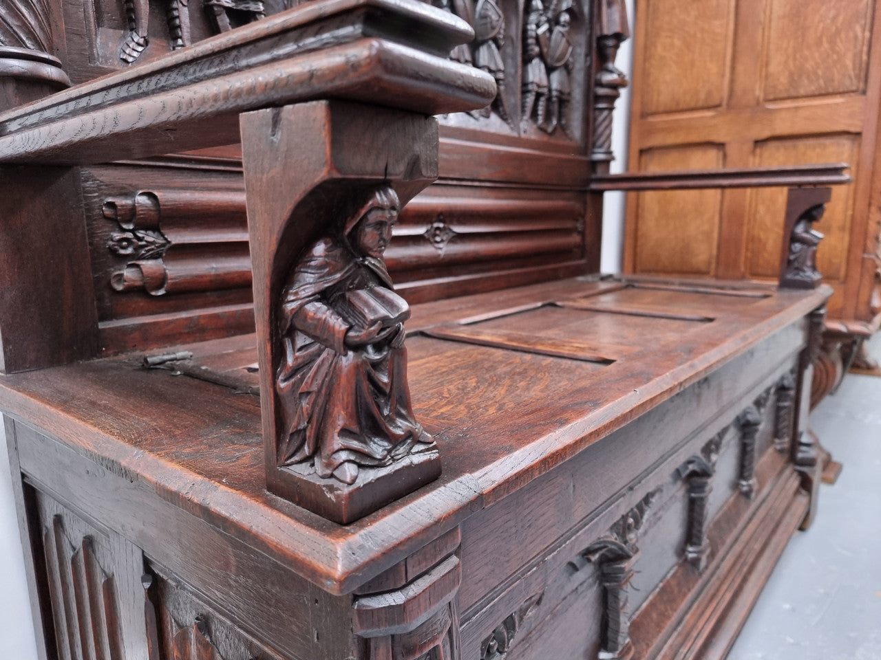 Early 19th Century French Oak Gothic style hall seat with a lift up seat. It has amazing detailed carvings and is in good original detailed condition.