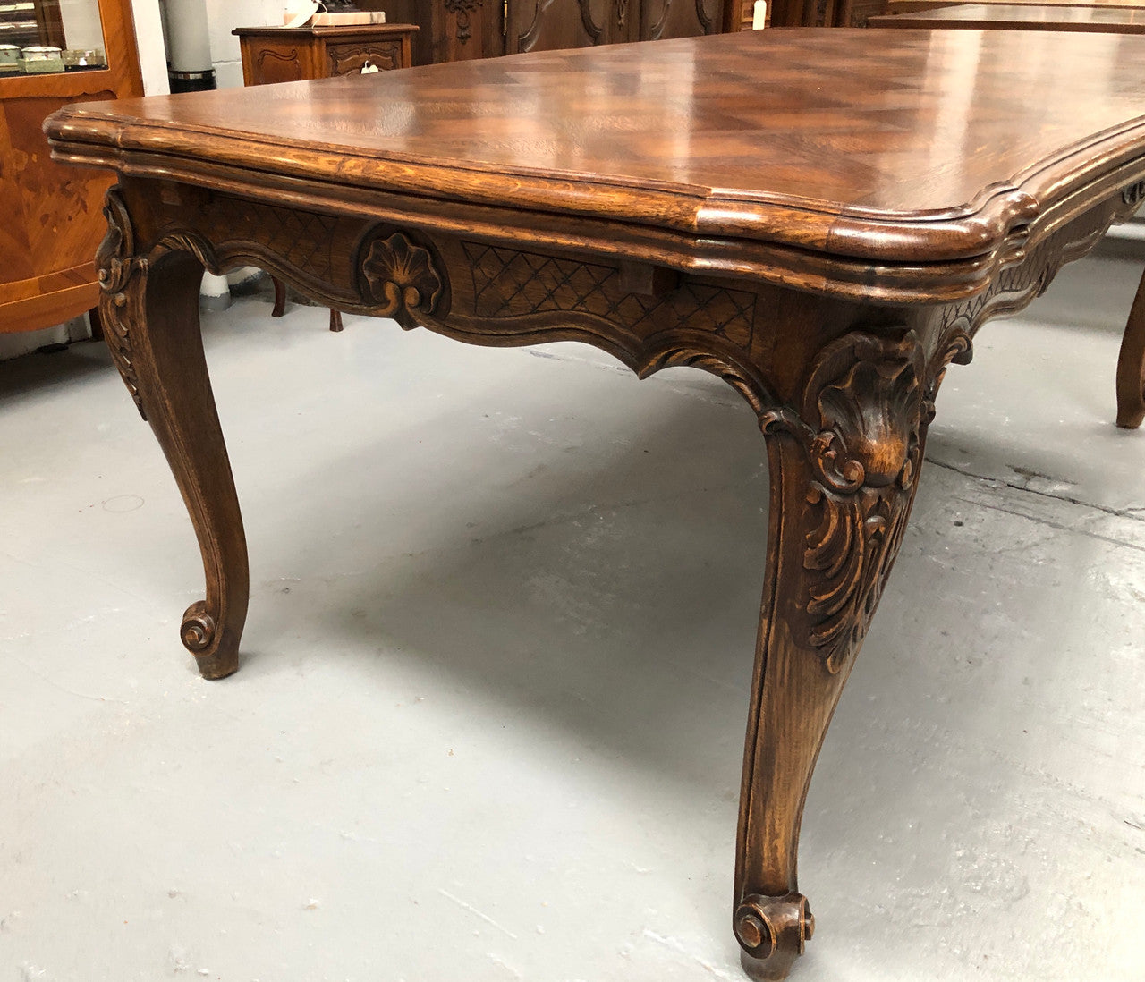 High quality French Oak Louis XV Style, beautifully carved extension table. It has an amazing parquetry top and when fully extended measures to 3 meters long. In very good original detailed condition.