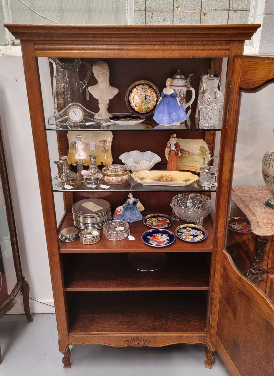French Oak Louis XV Style Vitrine with two fixed glass shelves at the top and two fixed wooden shelves at the base for added storage. It has been sourced from France and in good original detailed condition.