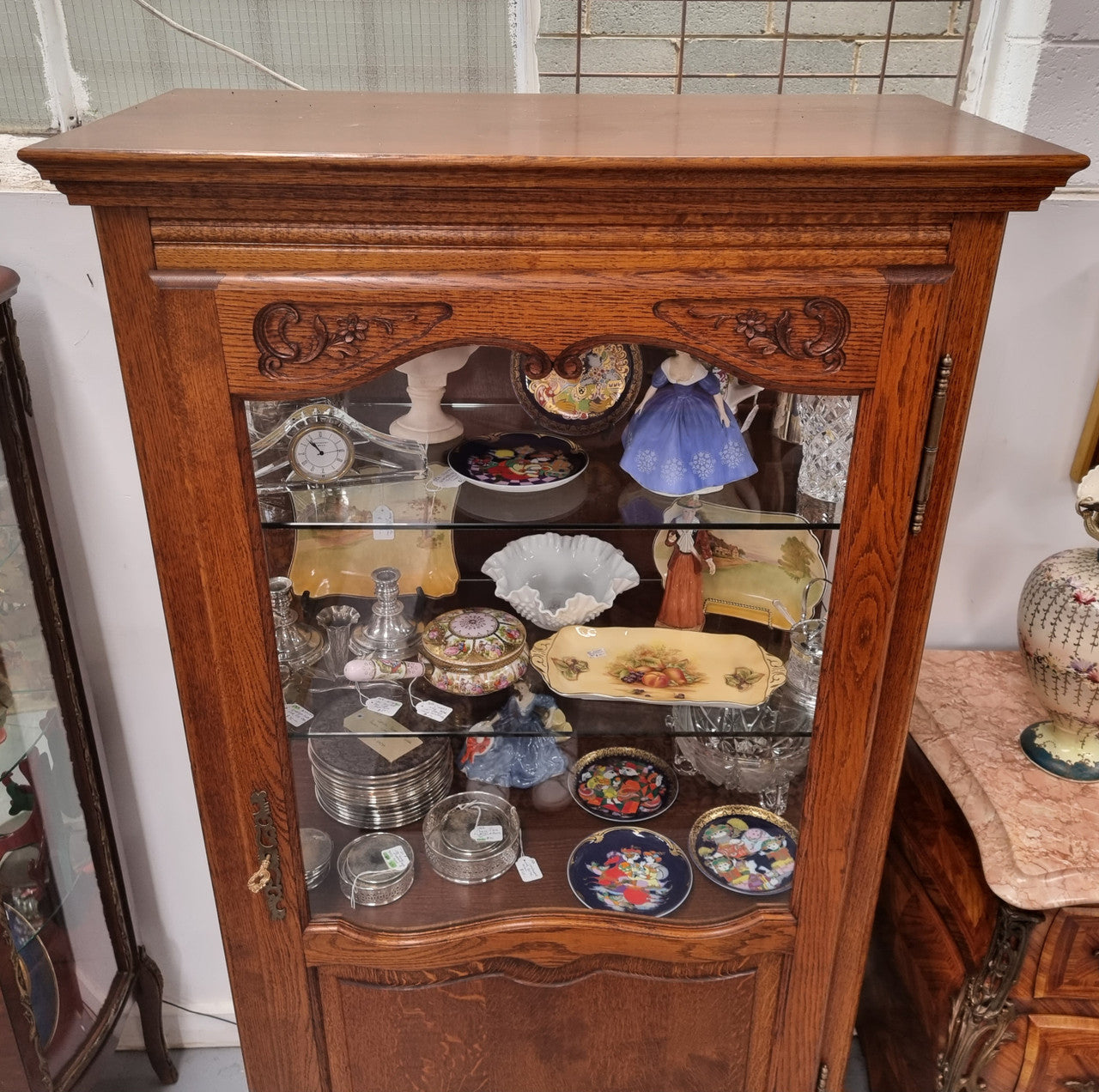 French Oak Louis XV Style Vitrine with two fixed glass shelves at the top and two fixed wooden shelves at the base for added storage. It has been sourced from France and in good original detailed condition.