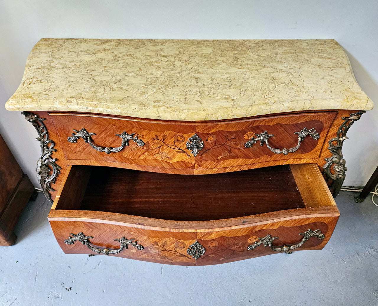 Stunning French Louis 15th style marble topped three drawer commode with marquetry inlay and stunning ormolu mounts. In good original detailed condition.