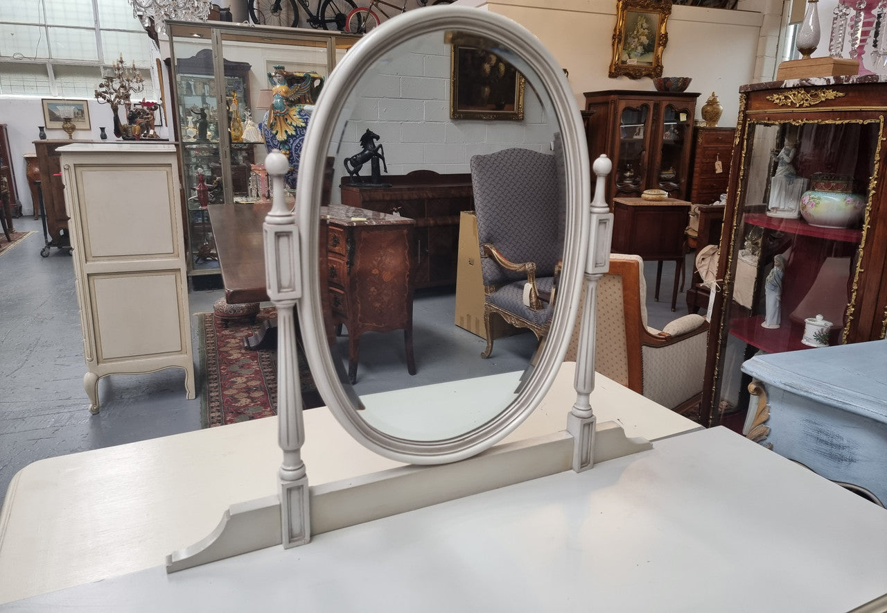 French Louis XVI style painted dresser / console with beveled oval mirror and three drawers. Sourced from France and in good original detailed condition.