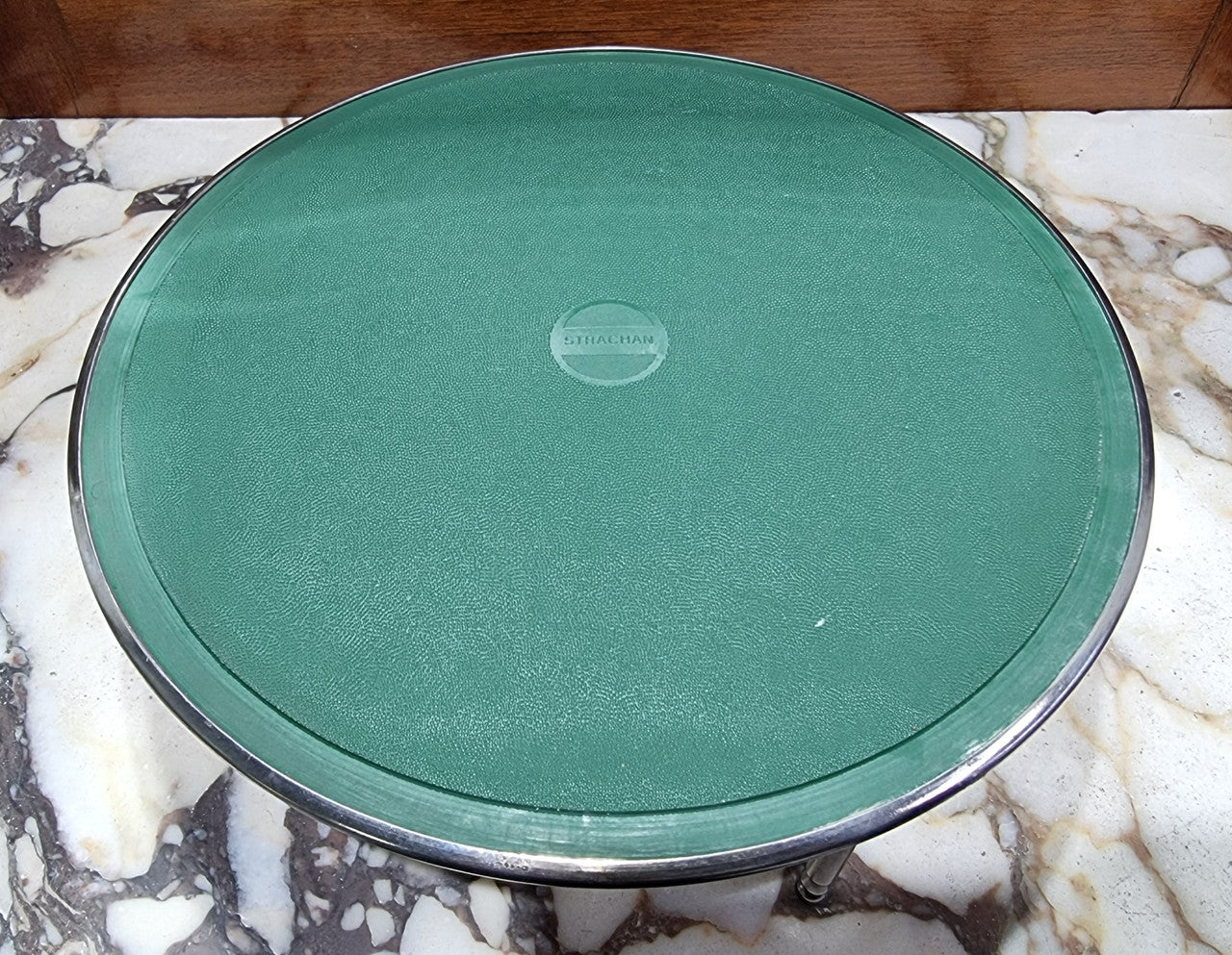 Five Strachan and two Rodd silver plate table coasters in a silver plate stand. In good original detailed condition.