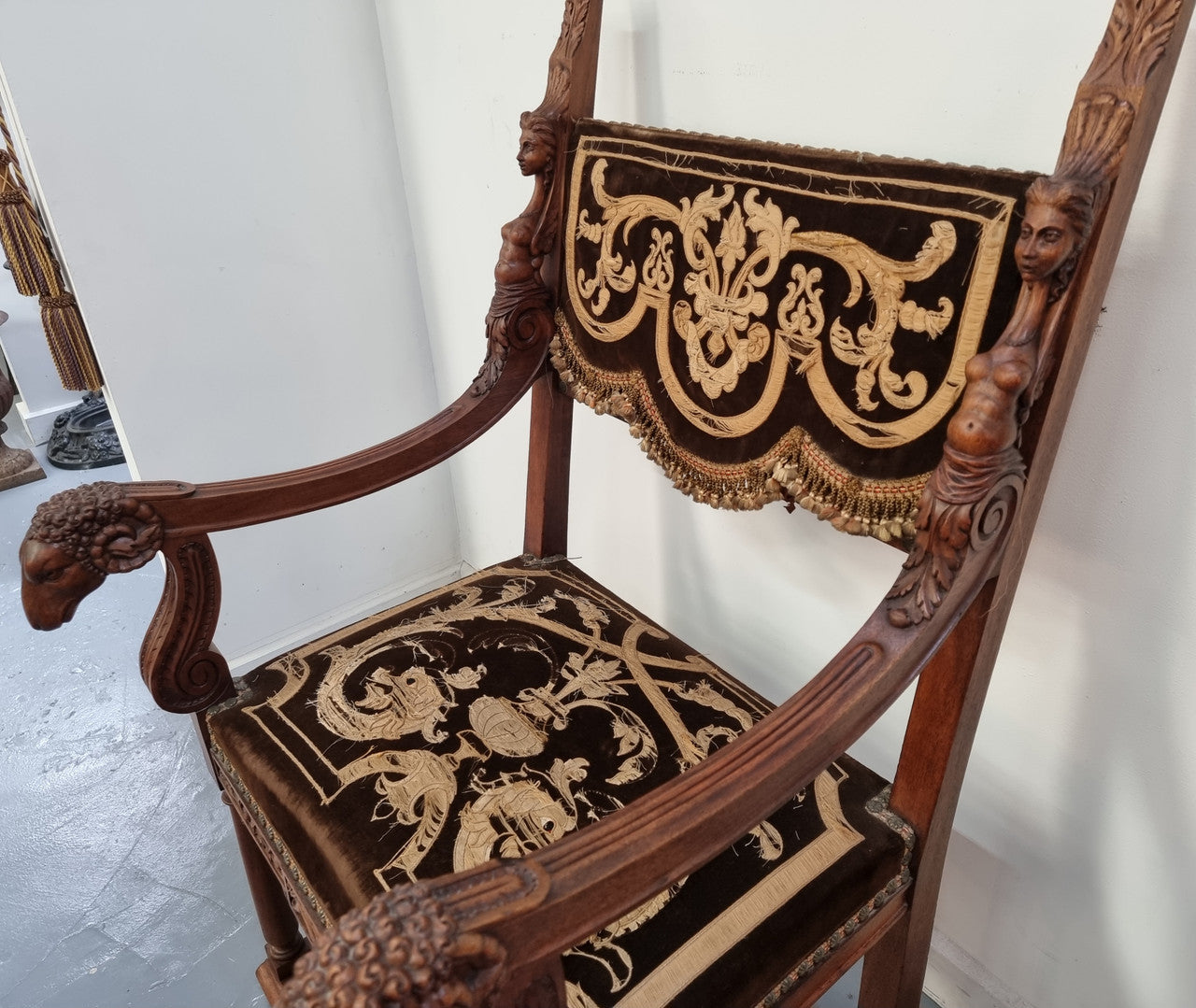 Beautifully carved Walnut Egyptian Revival armchair with amazing hand sewn Stumpwork embroidery coverings. In good original detailed condition.