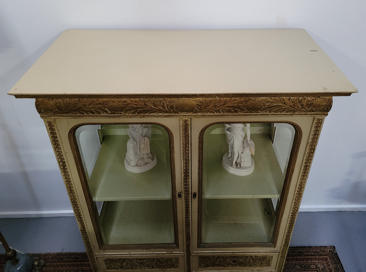 19th Century painted and gilt two door vitrine. Has one adjustable shelf and two drawers. In good original detailed condition.
