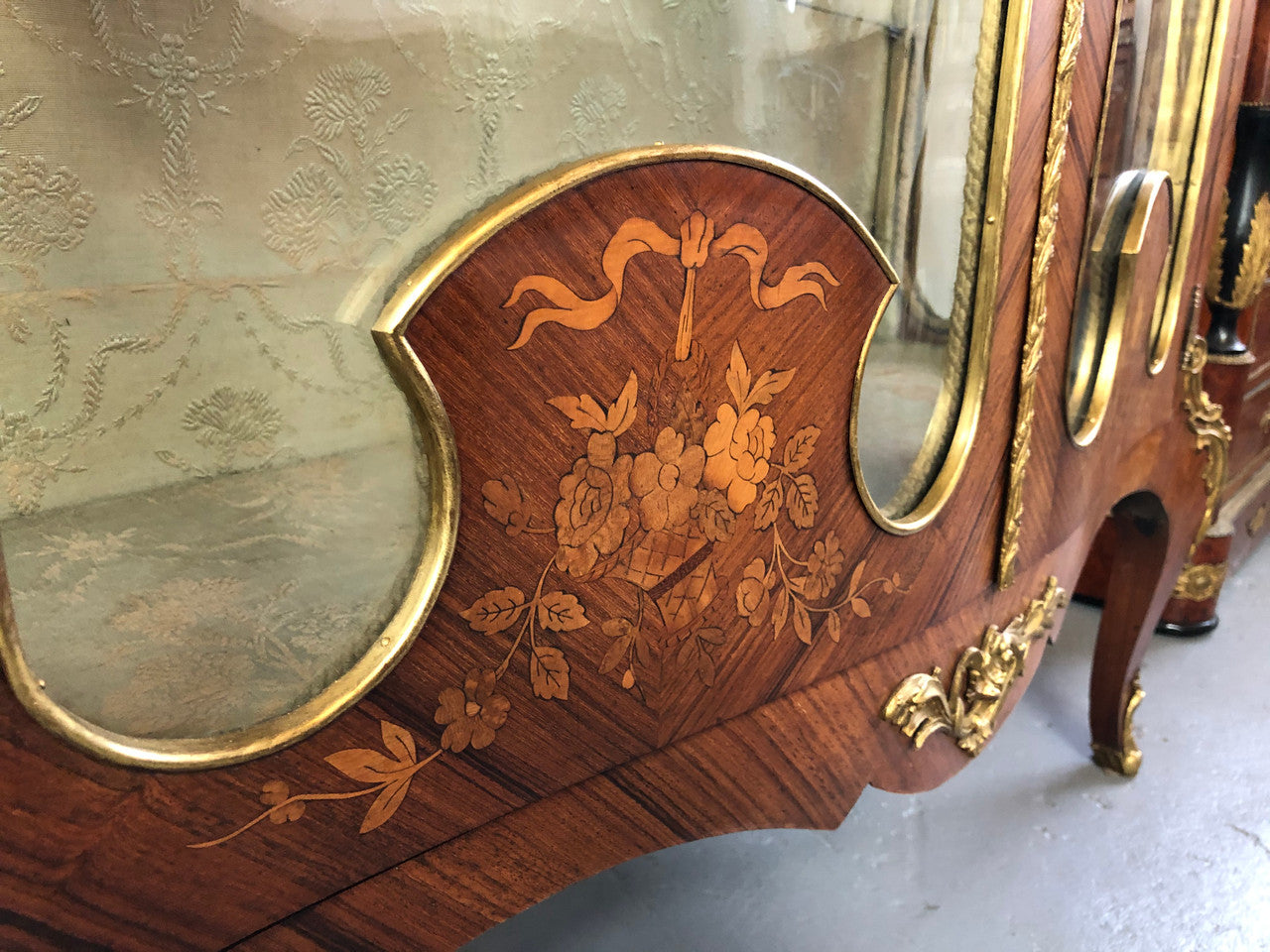 19th Century ornate French Walnut marquetry inlay display cabinet. Has beautiful ornate ormolu mounts and its original glass. In good original detailed condition.