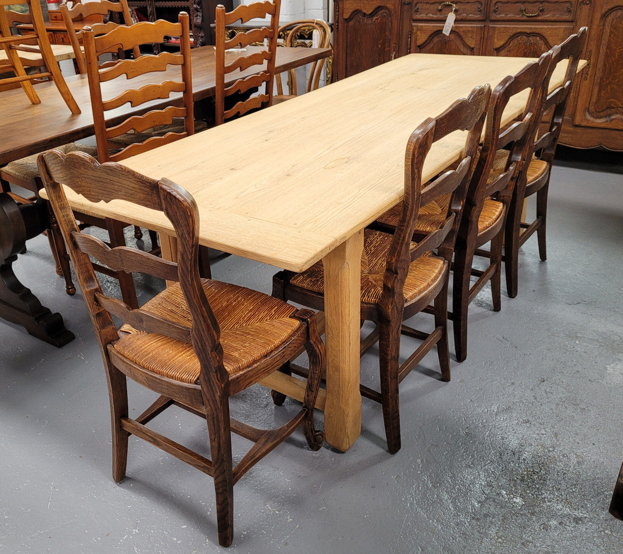 French raw Oak stretcher based refectory table. Features raw wood that could be used as is for a distressed look, or finished and waxed for a more refined look. Sourced from France and in good original condition.