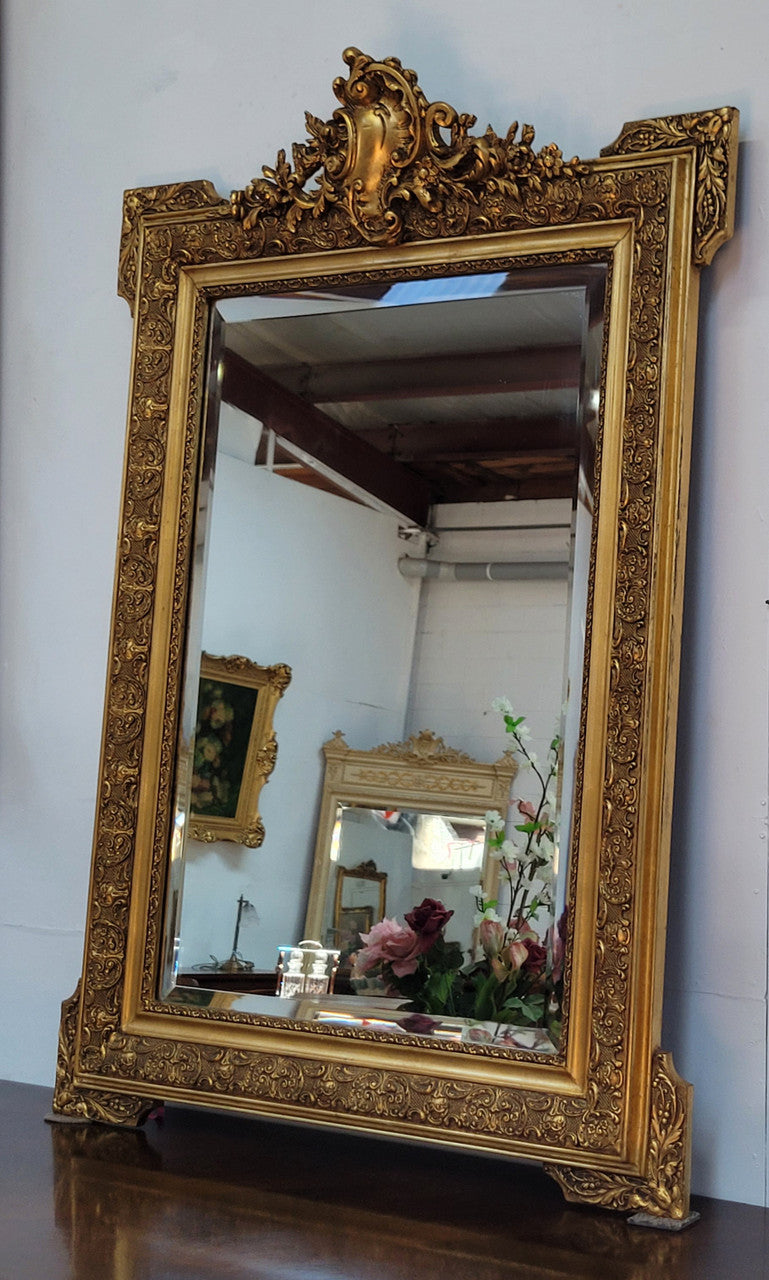 French 19th Century gilt over mantle mirror with beveled glass. In good original detailed condition.