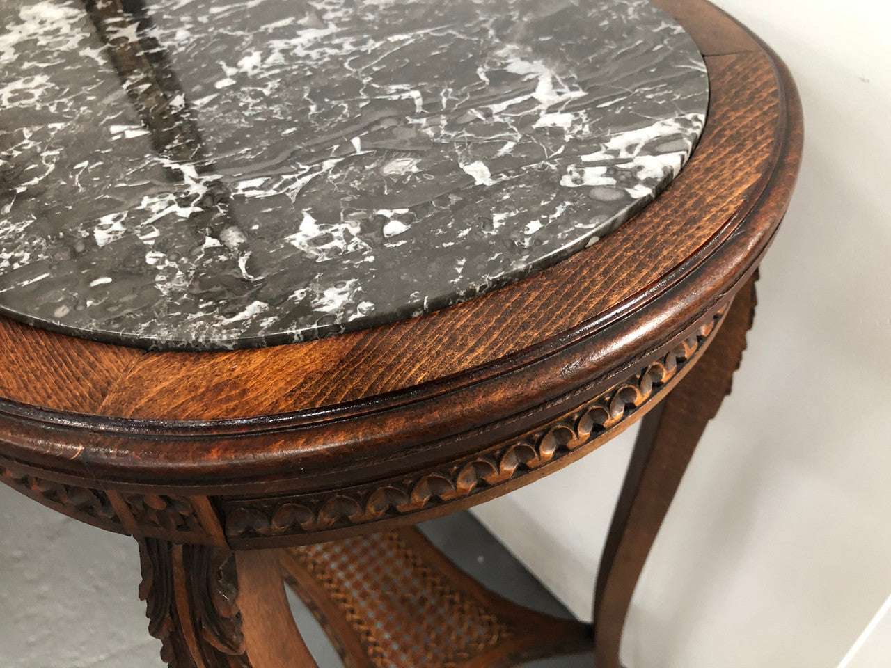 French Fruitwood marble top occasional table. It has two tiers with the bottom being made from cane. In good original condition. Circa 1920's.