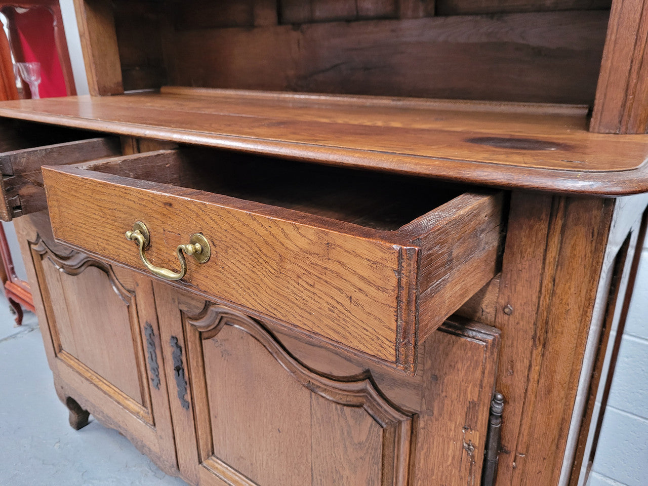 Charming 18th Century French Oak Vaisselier / kitchen dresser with two cupboard doors and three open shelves at the top. Sourced from France and in good original detailed condition.