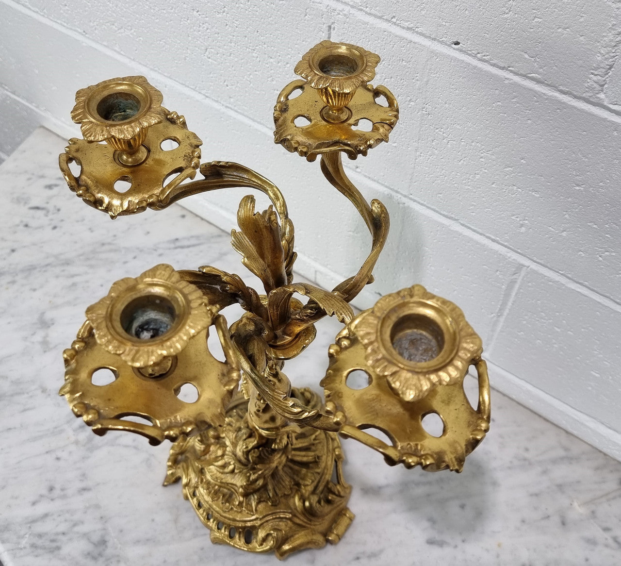 A pretty 19th Century French gilt bronze candelabra featuring a cherub. In good condition. Circa 1880.