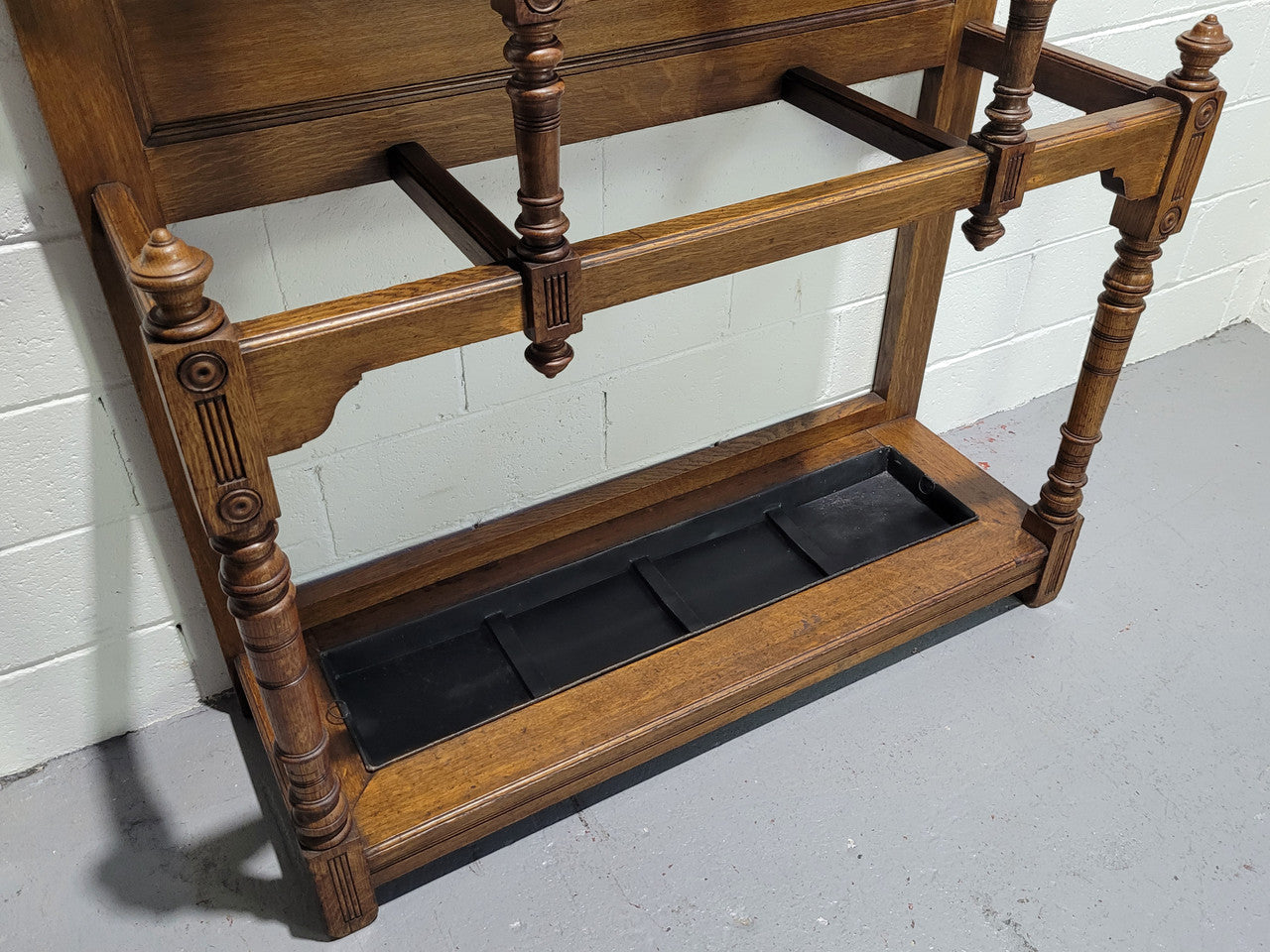 Impressive Oak hall stand of grand portions. Plenty of storage with a drawer, plenty of hooks and two sections for umbrealls/ walking sticks. It is in good original detailed condition.