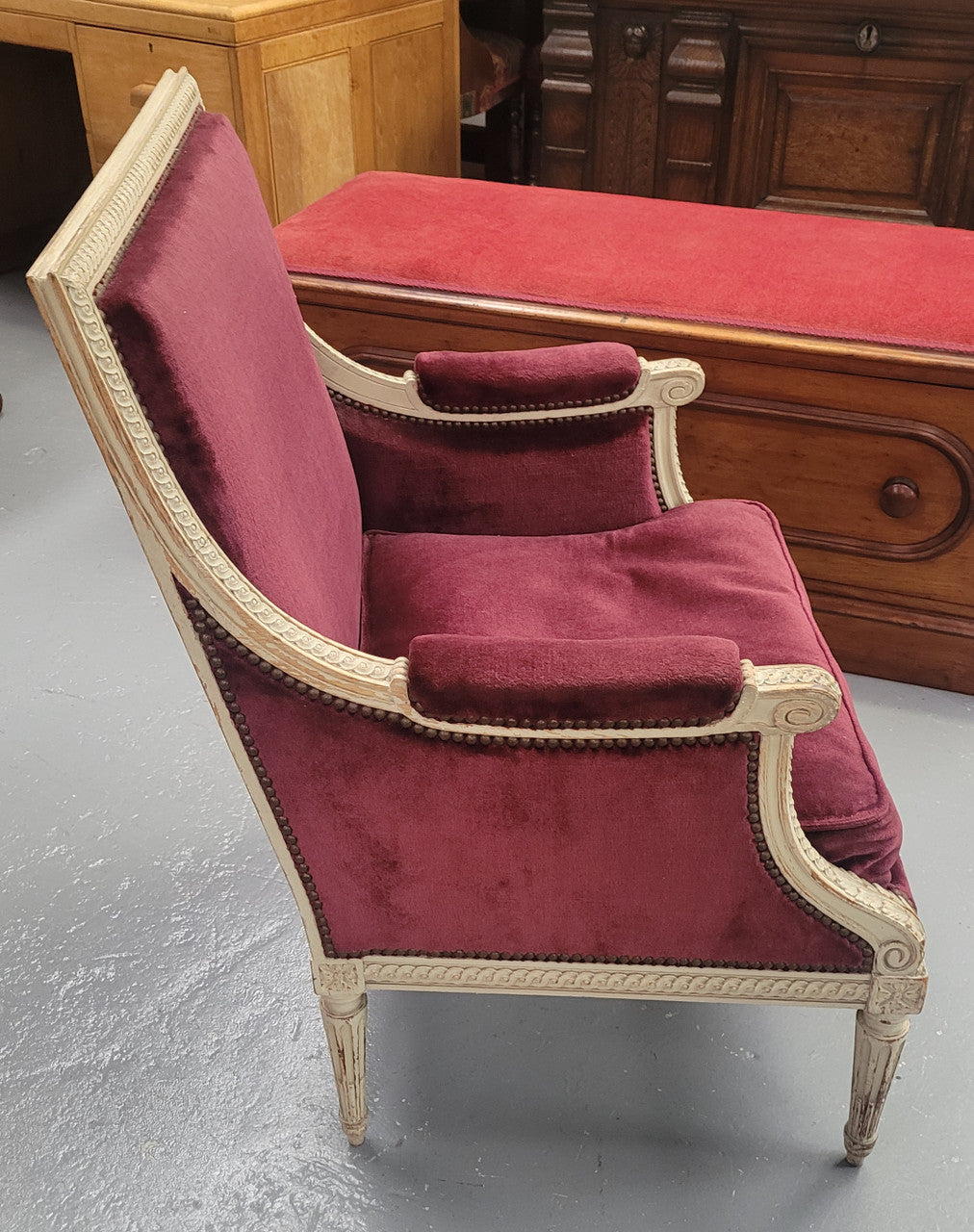 Louis 16th Style high back upholstered chair with maroon velvet fabric, decorative carvings and original paint. It has been sourced from France and in good original condition.