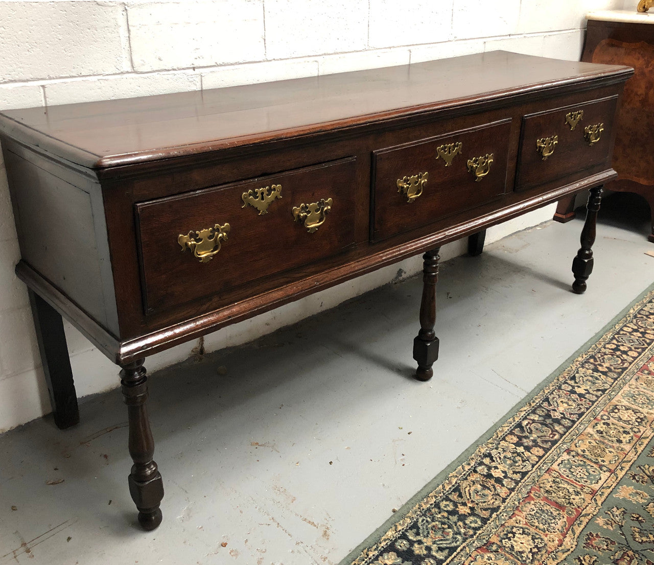 Early 19th Century English Oak dresser base with three large drawers. In very good original detailed condition.
