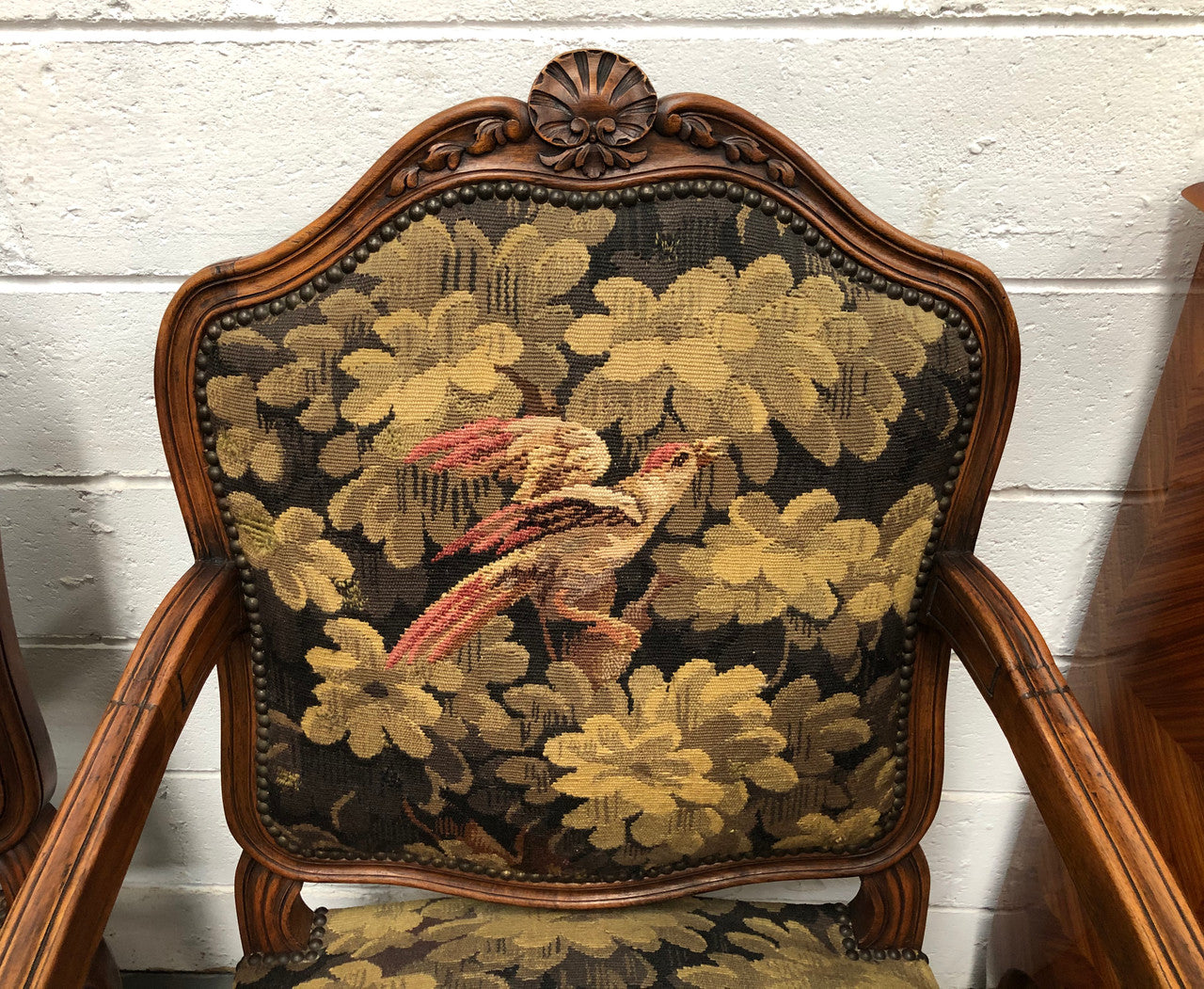 Pair of 19th Century French walnut tapestry covered arm chairs. They are in good original condition. Circa 1890.