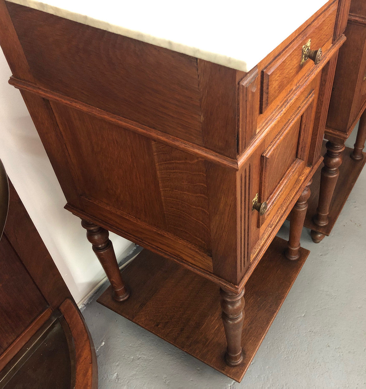 A lovely pair of French Oak, marble top bedside cabinets with a cupboard and drawer in good original condition.