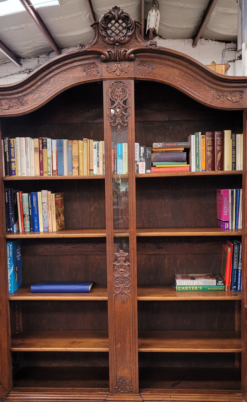 Substantial French Oak Louis 15th Style large two door bookcase. Adjustable shelves and very decorative carving. In good original detailed condition.