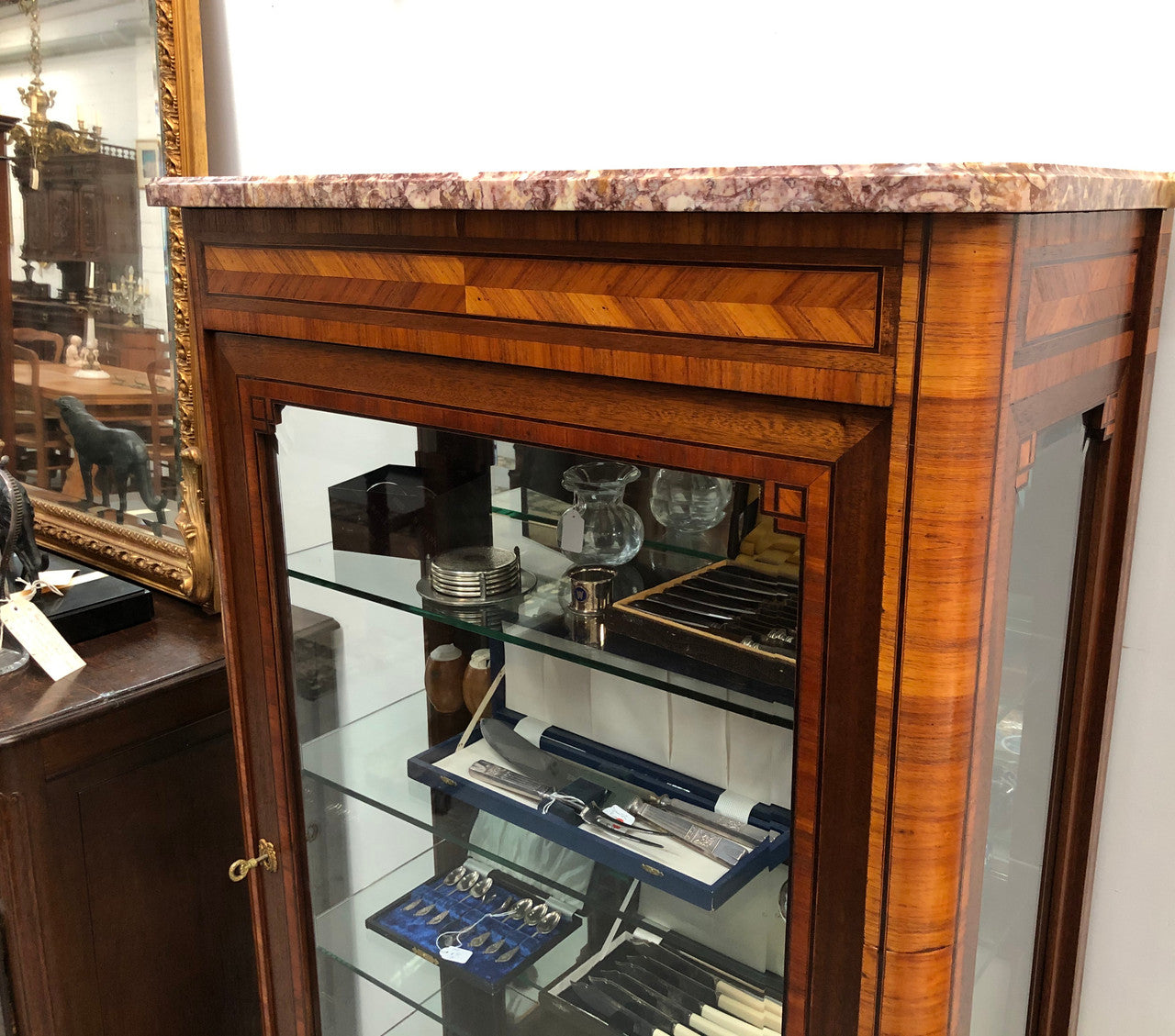 Beautiful French walnut and parquetry inlaid vitrine with lovely bevelled glass and a marble top. It comes with four glass shelves which are adjustable and it is in good original condition.