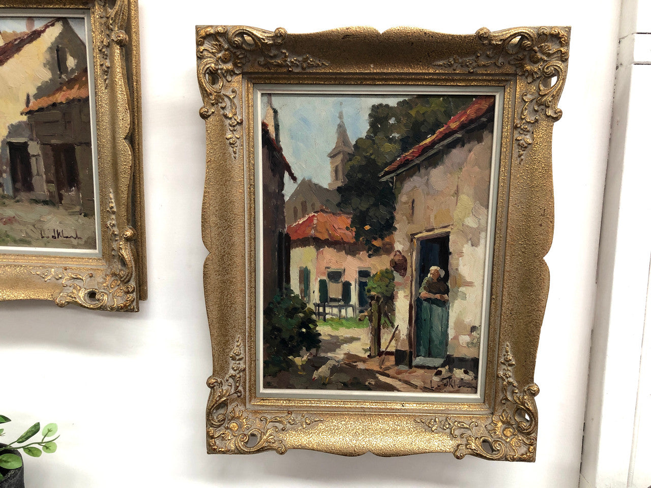 Pair of Vintage framed French oil on canvas of "Village Scenes". They are both in good original detailed condition.