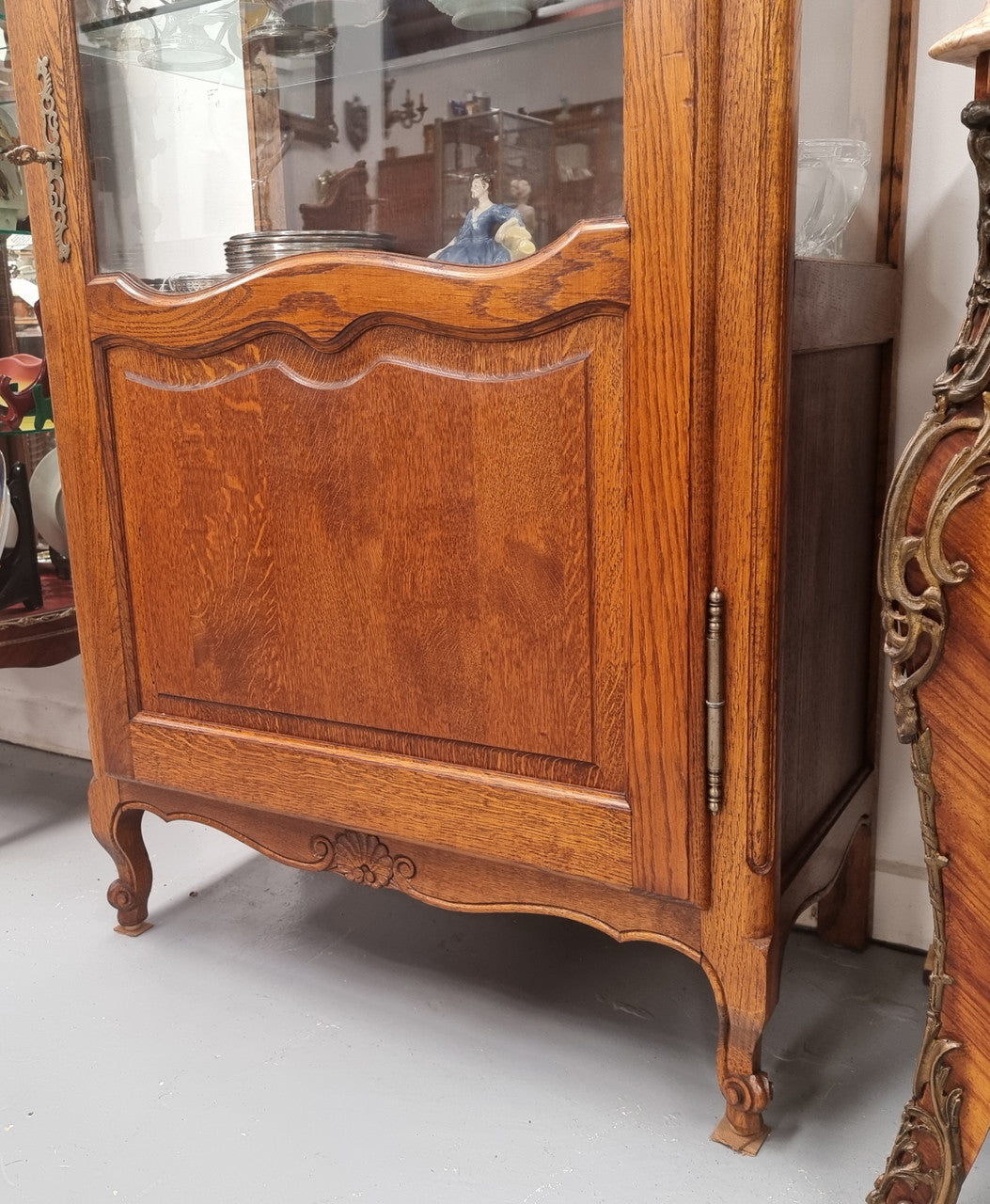 French Oak Louis XV Style Vitrine with two fixed glass shelves at the top and two fixed wooden shelves at the base for added storage. It has been sourced from France and in good original detailed condition.