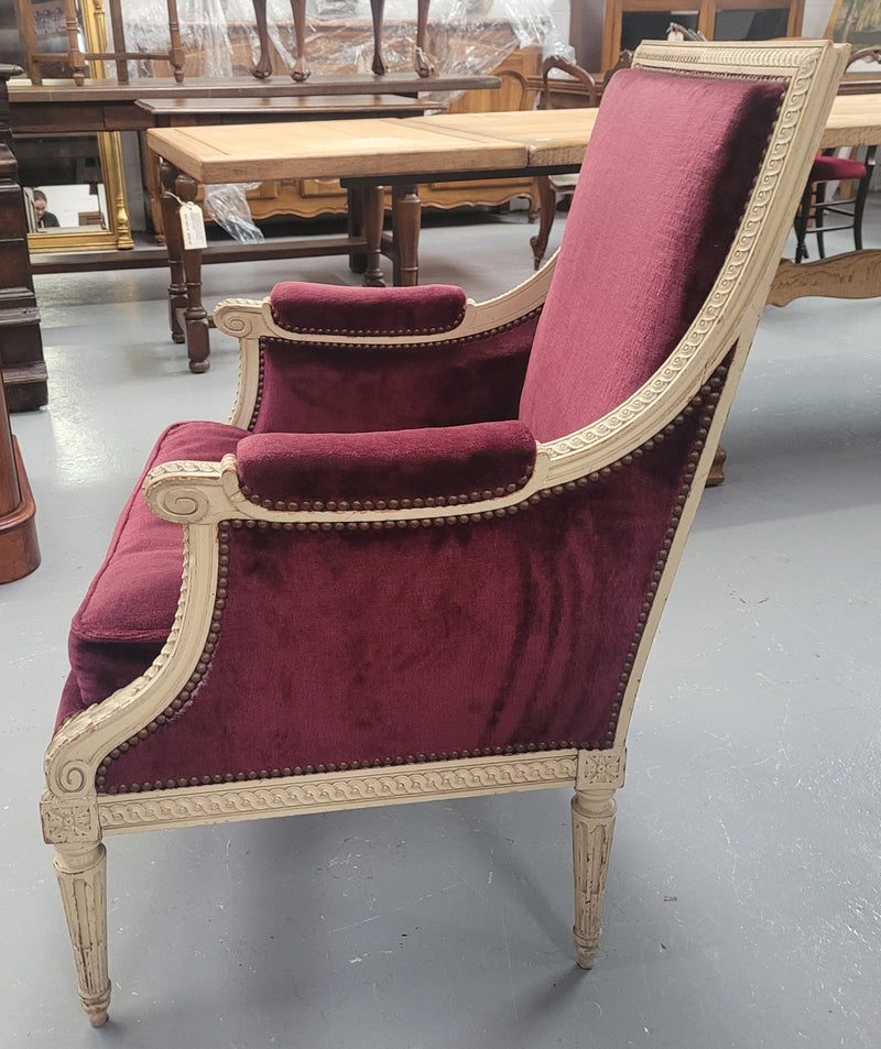 Louis 16th Style high back upholstered chair with maroon velvet fabric, decorative carvings and original paint. It has been sourced from France and in good original condition.