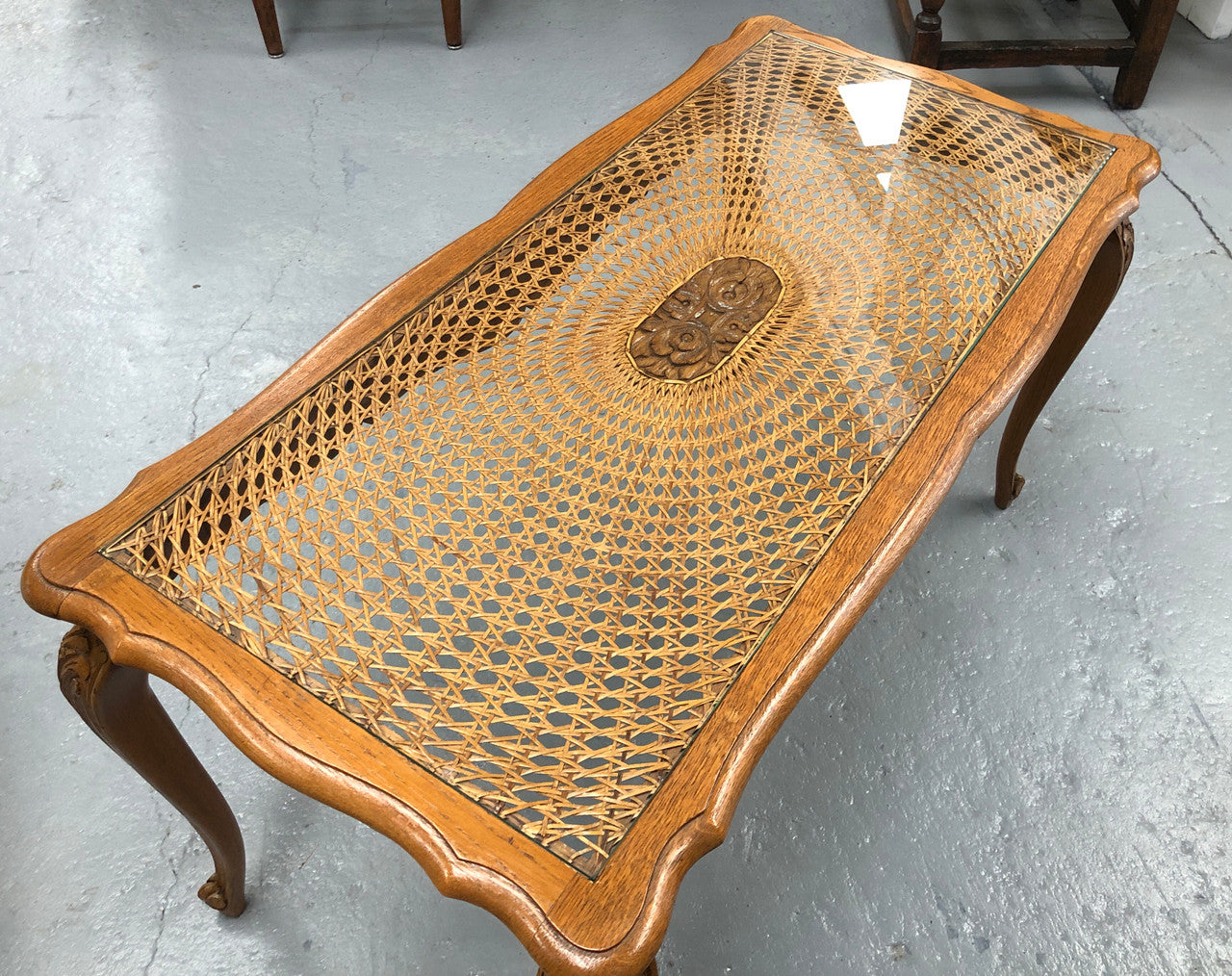 Lovely French Oak Louis XV style cane top coffee table with a glass top. In good original detailed condition.