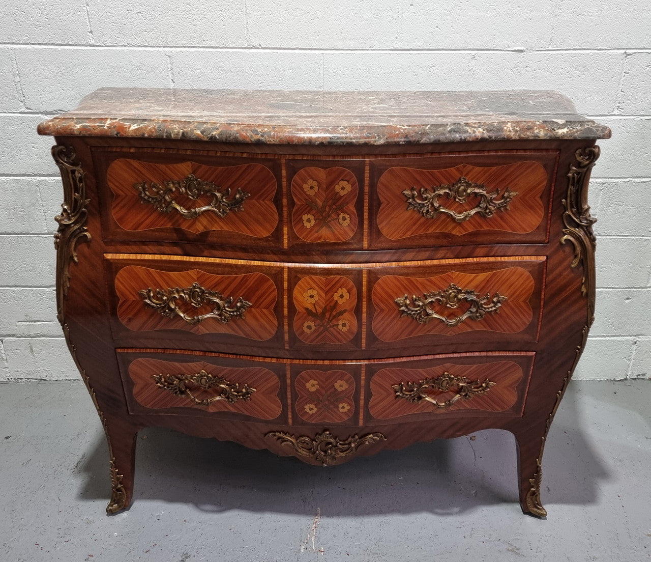 French Walnut and Kingwood Louis XV style marquetry inlaid commode with three drawers and a beautiful marble top. It is in good original detailed condition.