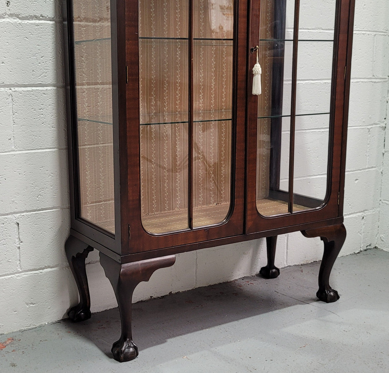 Chippendale style Walnut display cabinet of pleasing narrow portrions. It is in good original condition and comes with three shelves.