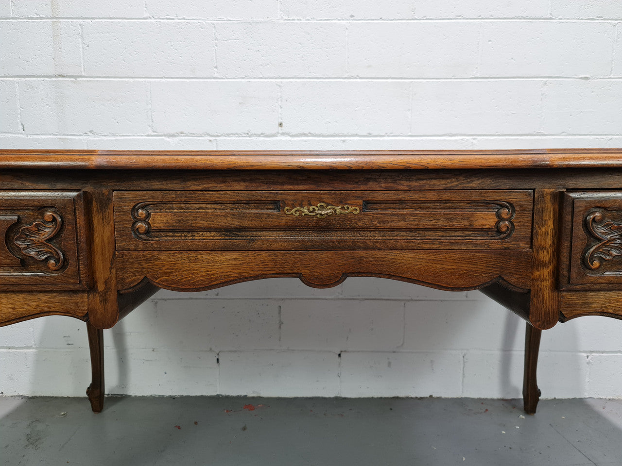Attractive large Louis XV style Oak faux partners desk. Nicely carved details with three large functioning drawers, and three faux drawers at the back. In good original detailed condition.