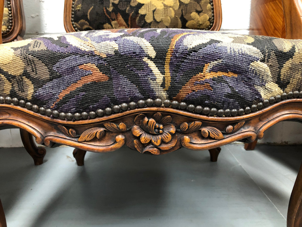 Pair of 19th Century French walnut tapestry covered arm chairs. They are in good original condition. Circa 1890.