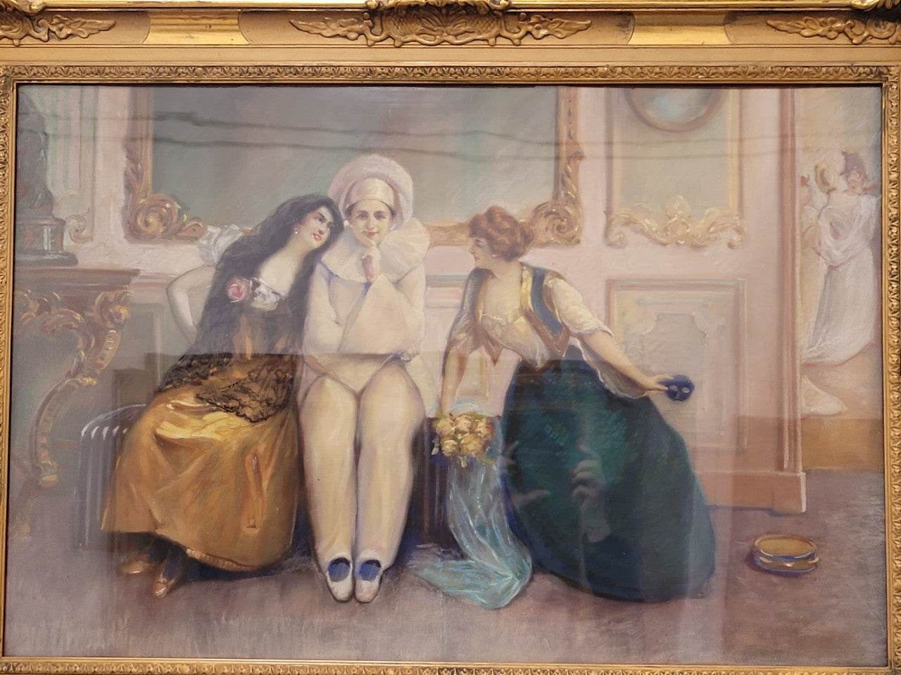 Delightful signed pastel behind glass of Pierrot and young women in an ornate gilt frame. In good original detailed condition.