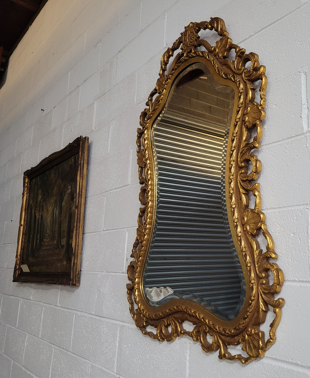 Large Vintage Italian carved wood gilt mirror. It has a beautiful bevelled mirror and has been sourced from France. It is in good original condition.
