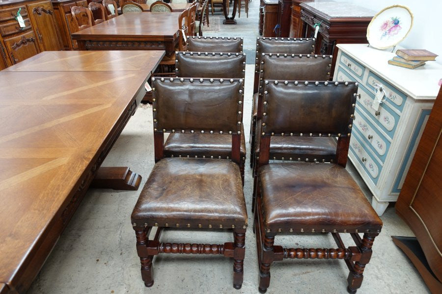Here we have a fabulous set of six French oak rustic leather dining chairs with two carvers. Chairs are upholstered in brown leather and are very comfortable and solid. Is in very good original condition.