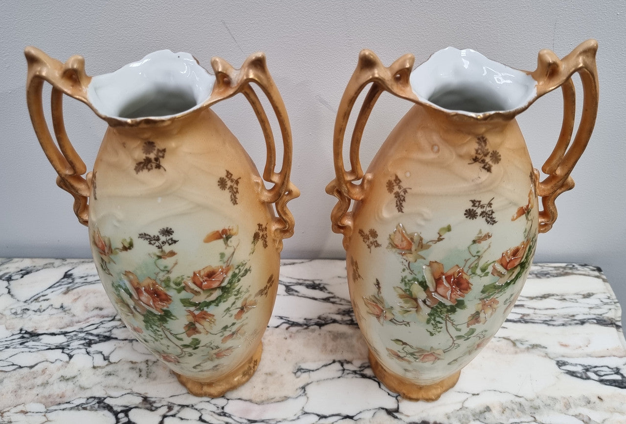 Decorative Pair of Art Nouveau Vases decorated with hand finished roses in muted tones. Gilt highlights. Impressed numbers to base. In good original condition, please view photos as they help form part of the description.
