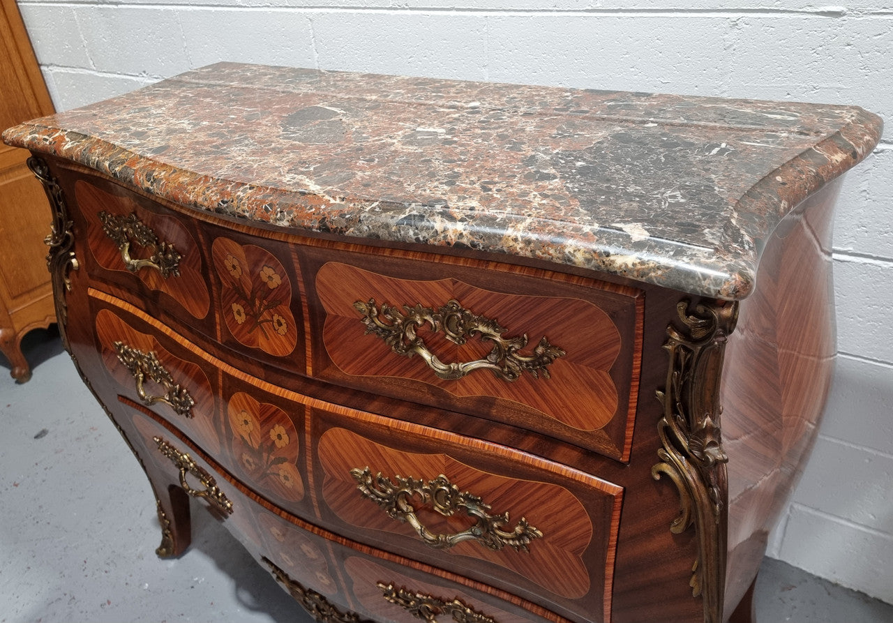 French Walnut and Kingwood Louis XV style marquetry inlaid commode with three drawers and a beautiful marble top. It is in good original detailed condition.
