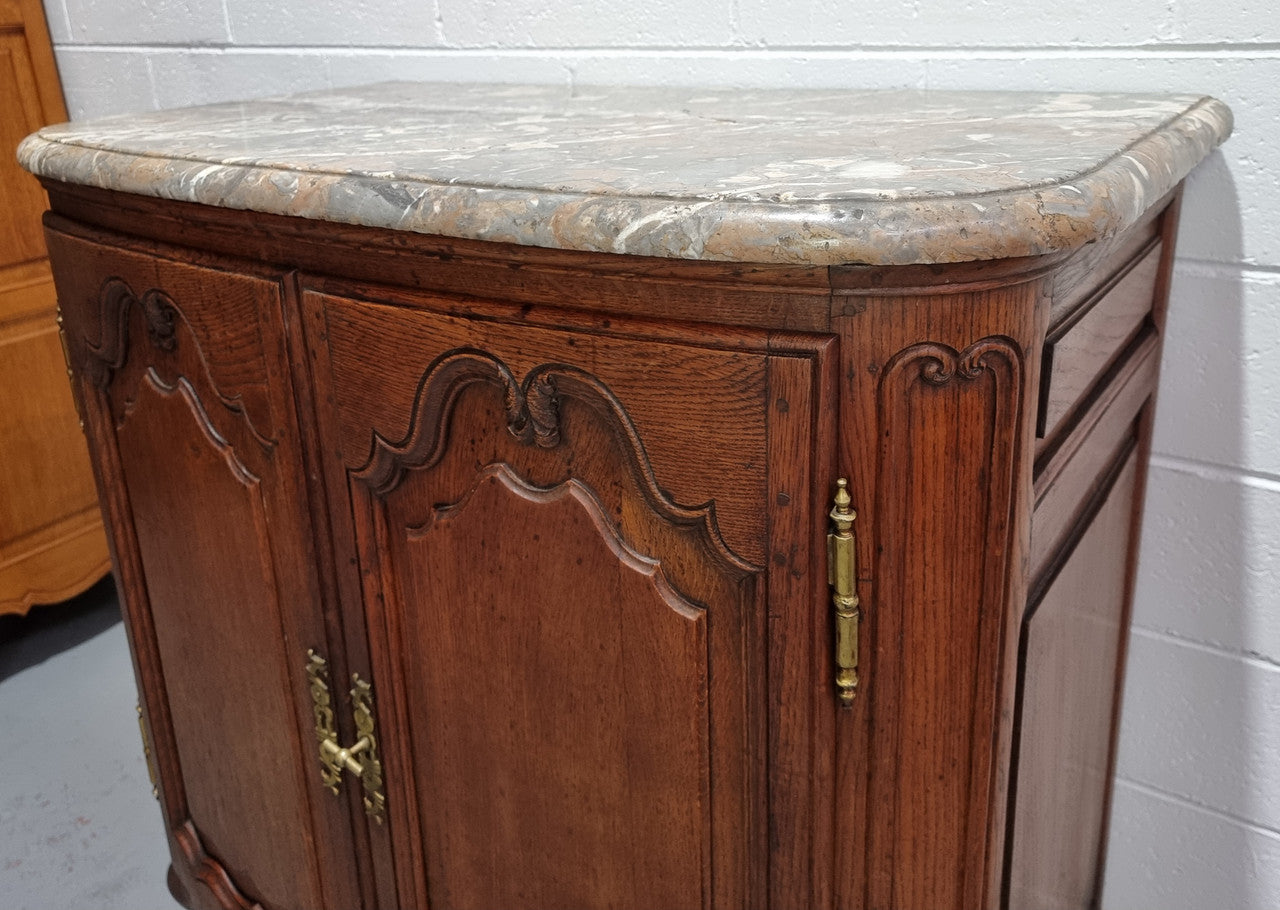 Rare 19th Century French Oak and marble top oval buffet / cabinet. Stunning thick marble top and decorative handles. In good original detailed condition.