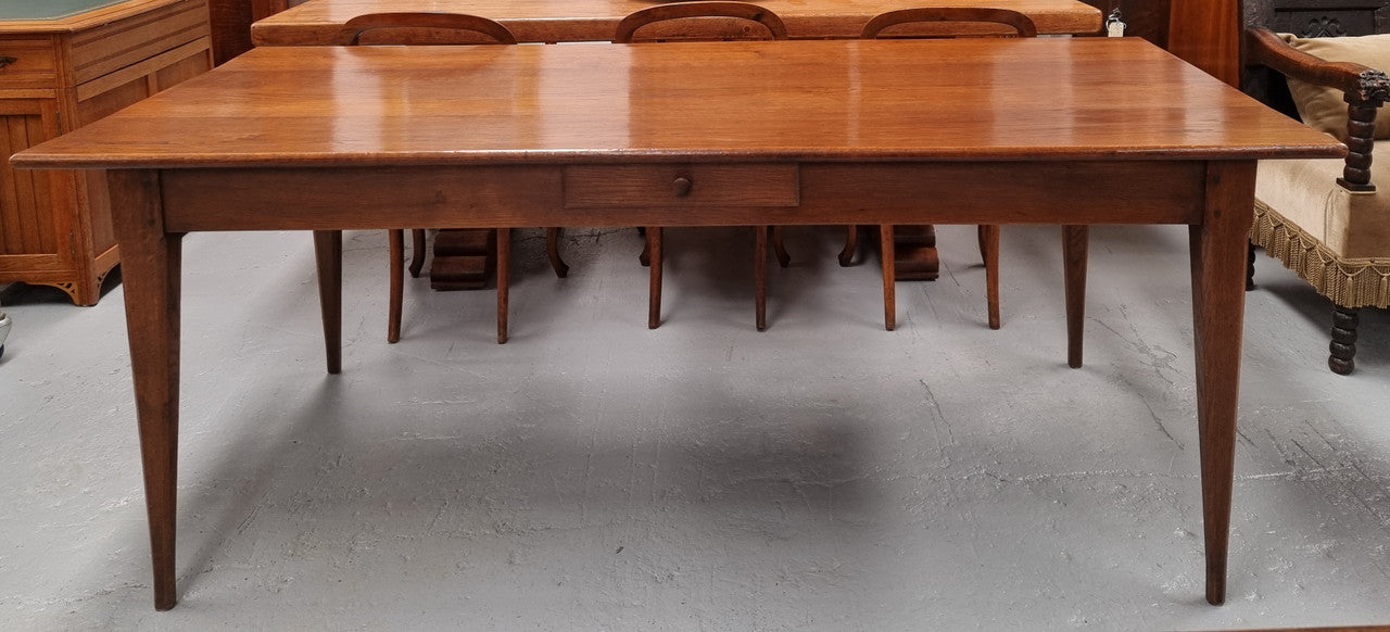 Antique French Oak Farmhouse table in fully restored condition. Features a single drawer and tapered legs.