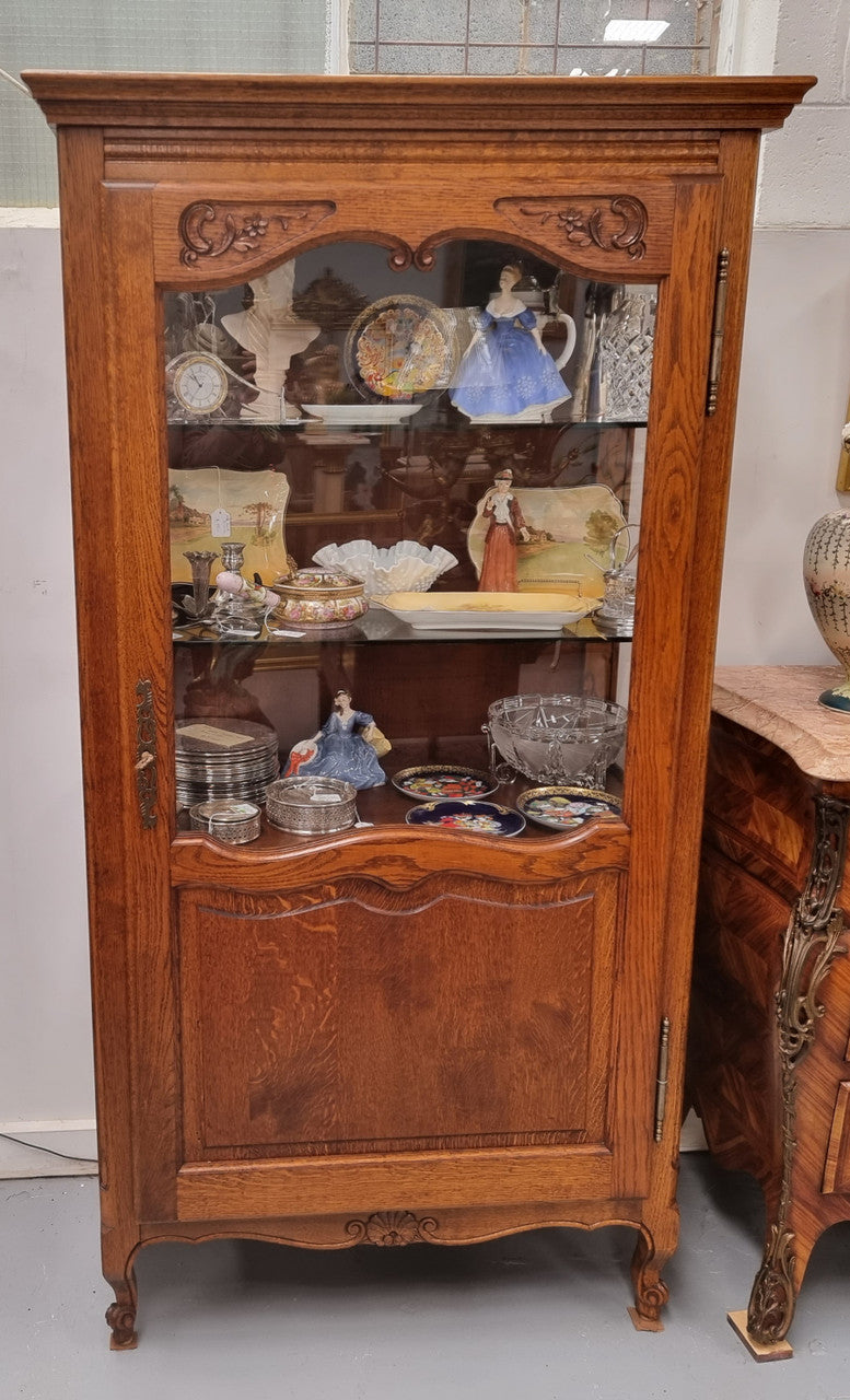 French Oak Louis XV Style Vitrine with two fixed glass shelves at the top and two fixed wooden shelves at the base for added storage. It has been sourced from France and in good original detailed condition.