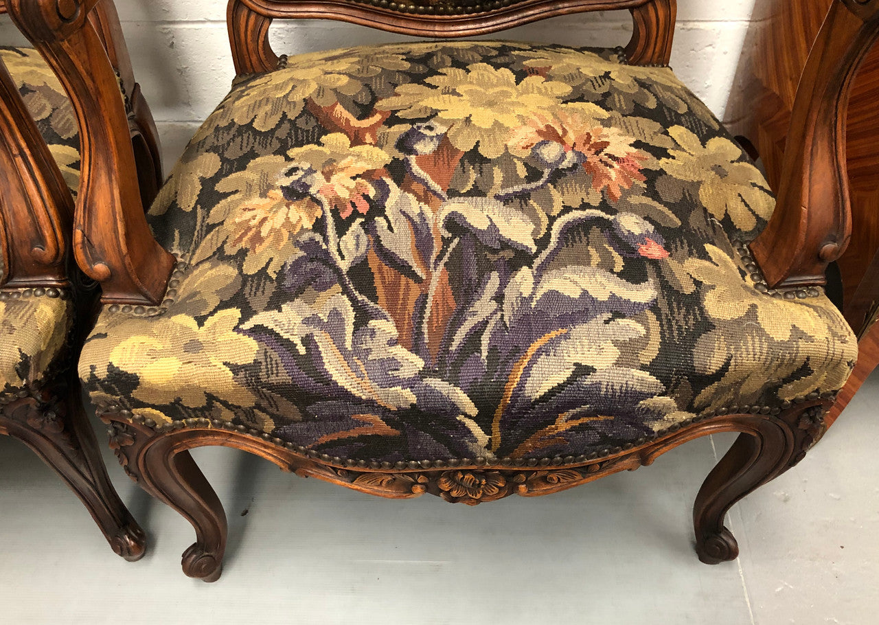 Pair of 19th Century French walnut tapestry covered arm chairs. They are in good original condition. Circa 1890.