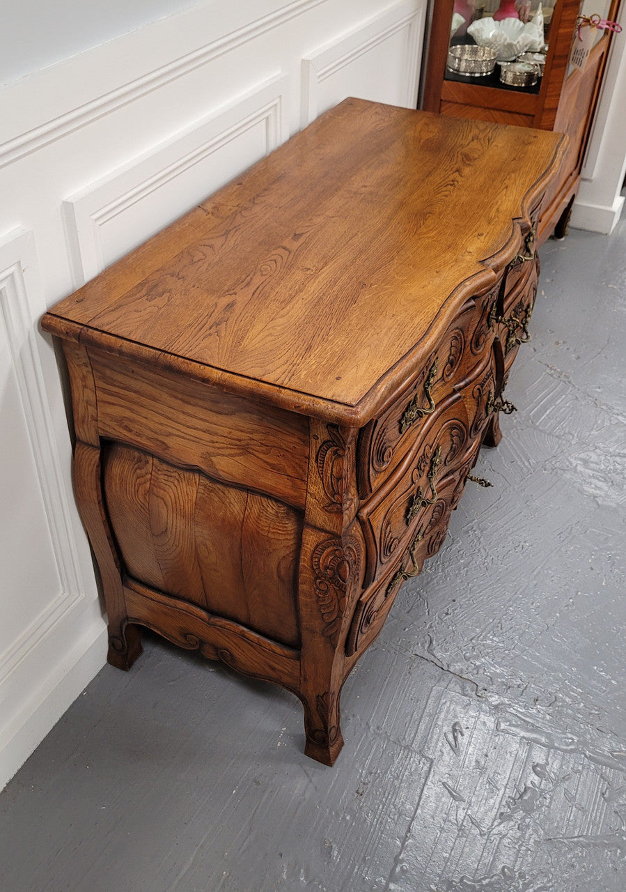French Antique Louis XIV style Oak wooden top commode. It has a stunning serpentine bombe shape front along with amazing handles and carvings. It comes with three beautiful keys as pictured and comes with working locks. It has been sourced from France and in good original detailed condition.